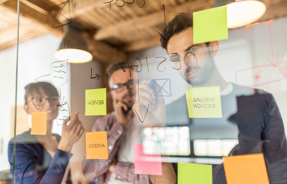 a group of transcreators brainstorming in their office